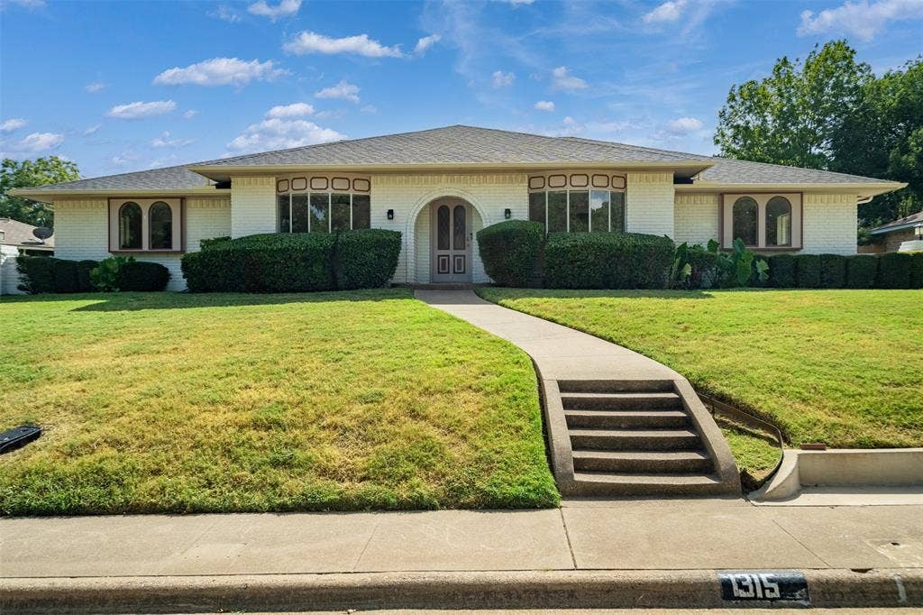 1315 Winding Brook Drive, DeSoto, TX 75115 White brick facade with arch-top entry door