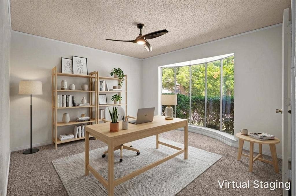 1315 Winding Brook Drive, DeSoto, TX 75115 Curved bay window, textured ceiling, ceiling fan, and wall-to-wall carpeting