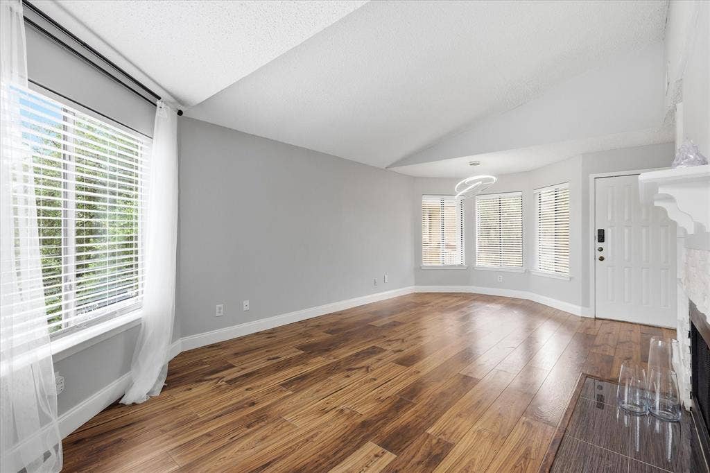 5550 Spring Valley Road, #A31, Dallas, TX 75254 Spacious interior with vaulted ceilings and wood-finish flooring