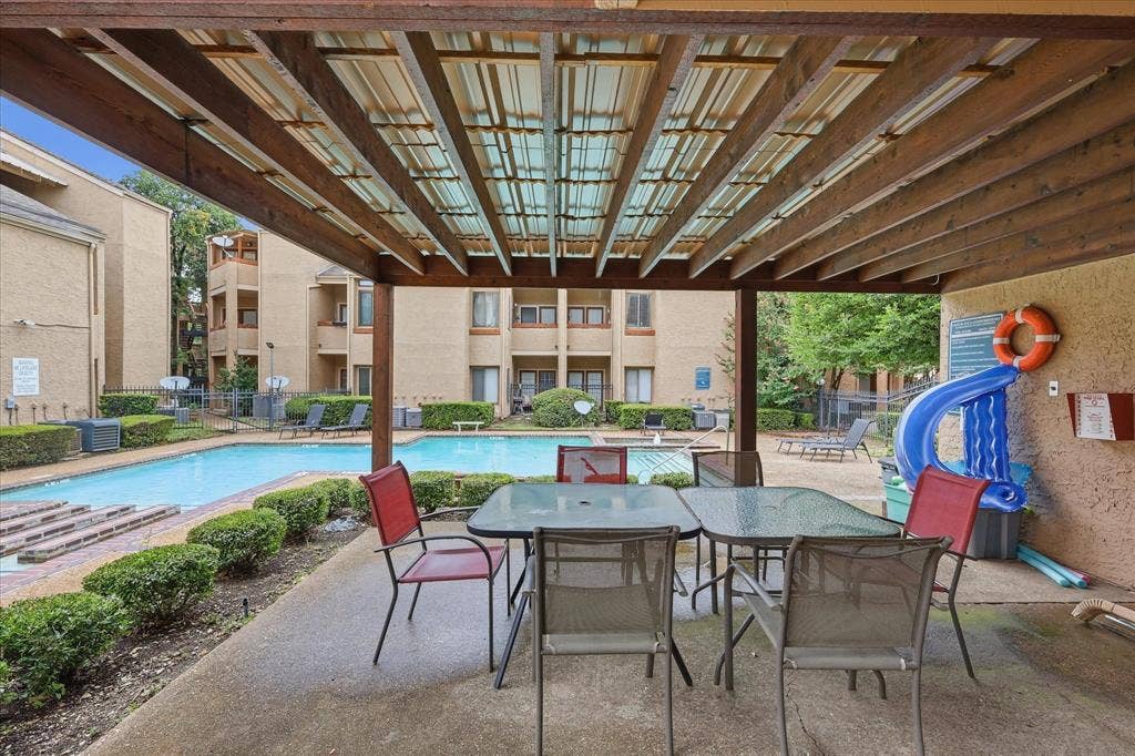 5550 Spring Valley Road, #A31, Dallas, TX 75254 Covered patio area featuring a slatted wooden pergola and concrete flooring