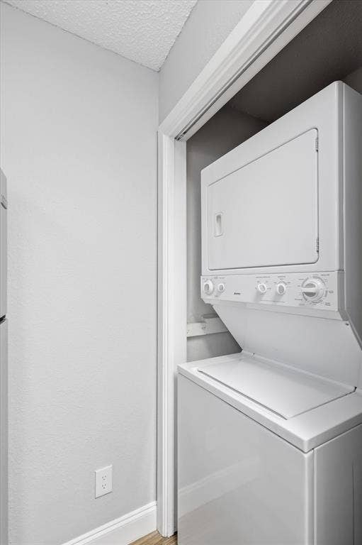 5550 Spring Valley Road, #A31, Dallas, TX 75254 Dedicated laundry closet featuring a white stackable washer and dryer unit