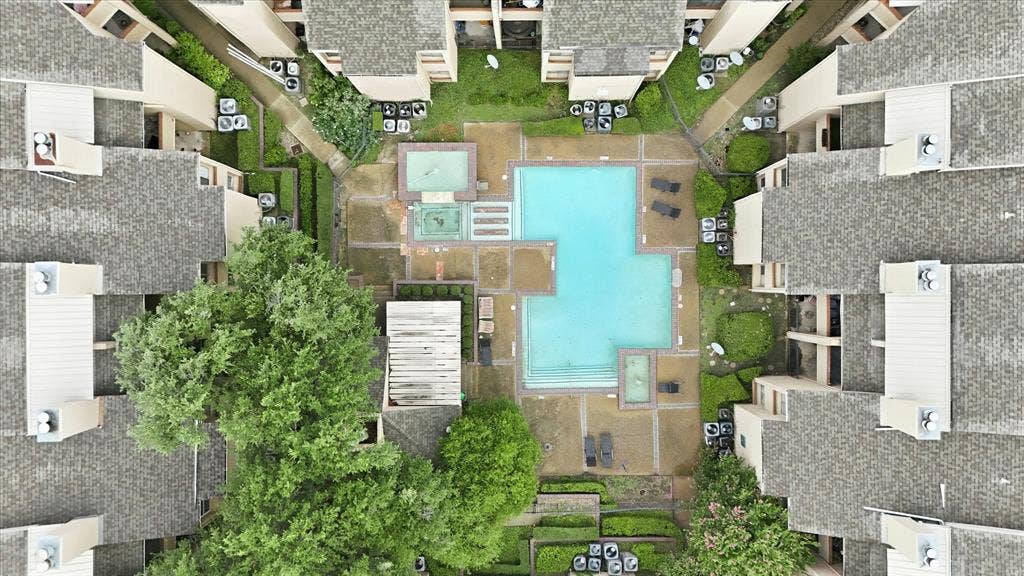 5550 Spring Valley Road, #A31, Dallas, TX 75254 Central courtyard featuring a rectangular pool, a separate spa, and surrounding paved patio areas