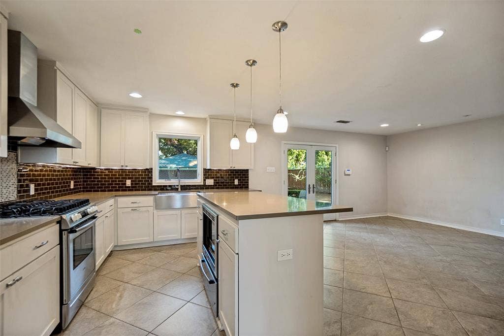 Updated appliances and cabinets galore. Quartz counters.