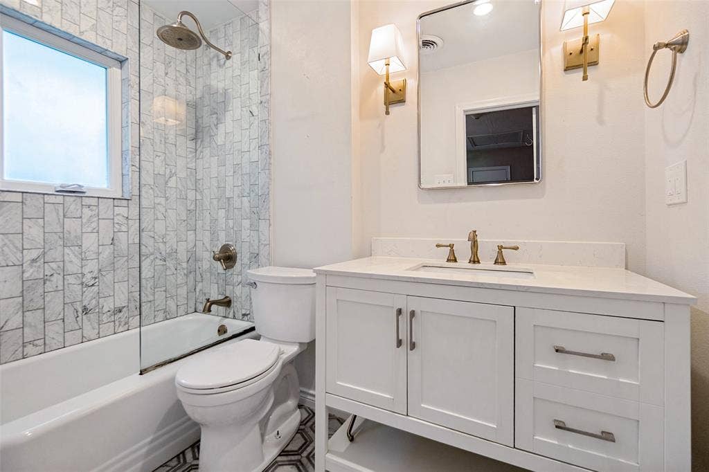 Updated ensuite bath with marble accents and designer scones.