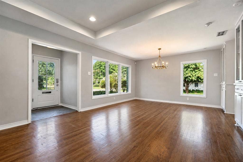 Entry door with divided light, tray ceiling and natural light