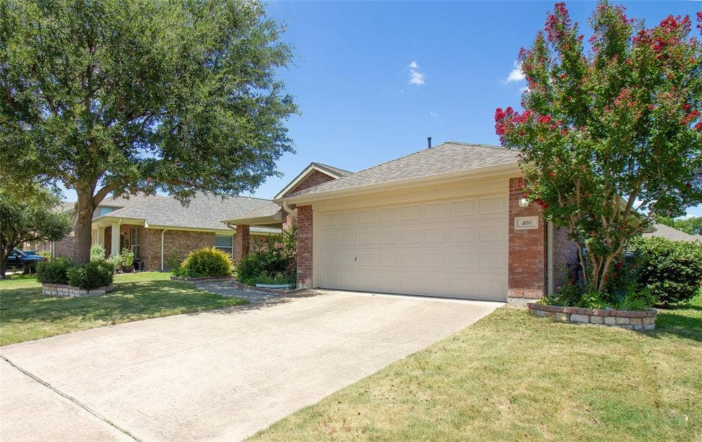 406 Hackberry Drive, Fate, TX 75087 Brick veneer exterior with an attached two-car garage