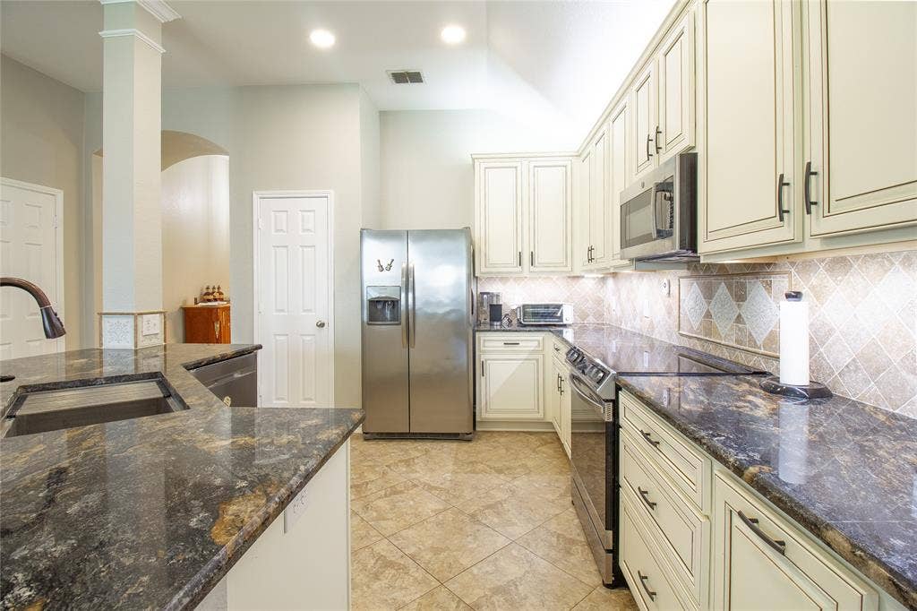 406 Hackberry Drive, Fate, TX 75087 Kitchen featuring granite countertops, stainless steel appliances, light cabinetry, tile flooring, and recessed lighting