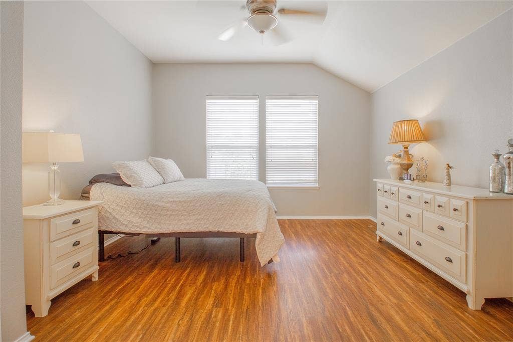 406 Hackberry Drive, Fate, TX 75087 Spacious room featuring wood-finish flooring, vaulted ceilings, and a ceiling fan