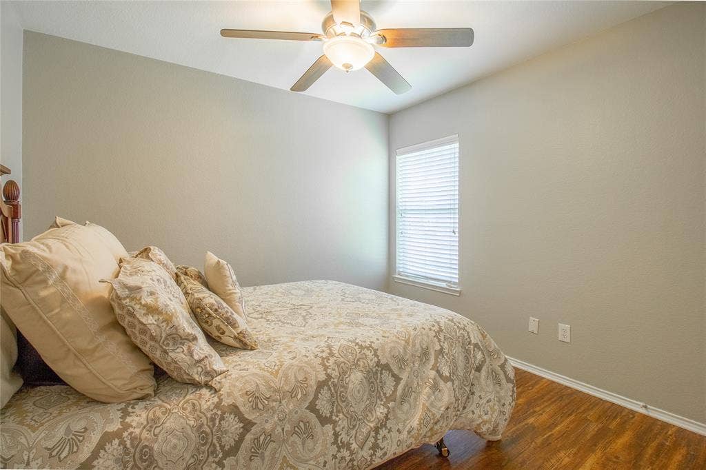 406 Hackberry Drive, Fate, TX 75087 Room featuring wood-finish flooring, a ceiling fan with integrated lighting, and neutral wall tones