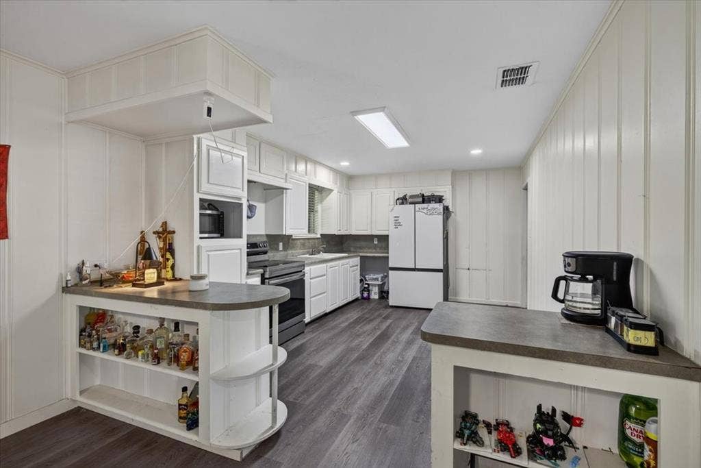 925 Maryland Drive, Athens, TX 75751 Kitchen featuring white cabinetry, grey countertops, stainless steel appliances, and wood-finish flooring