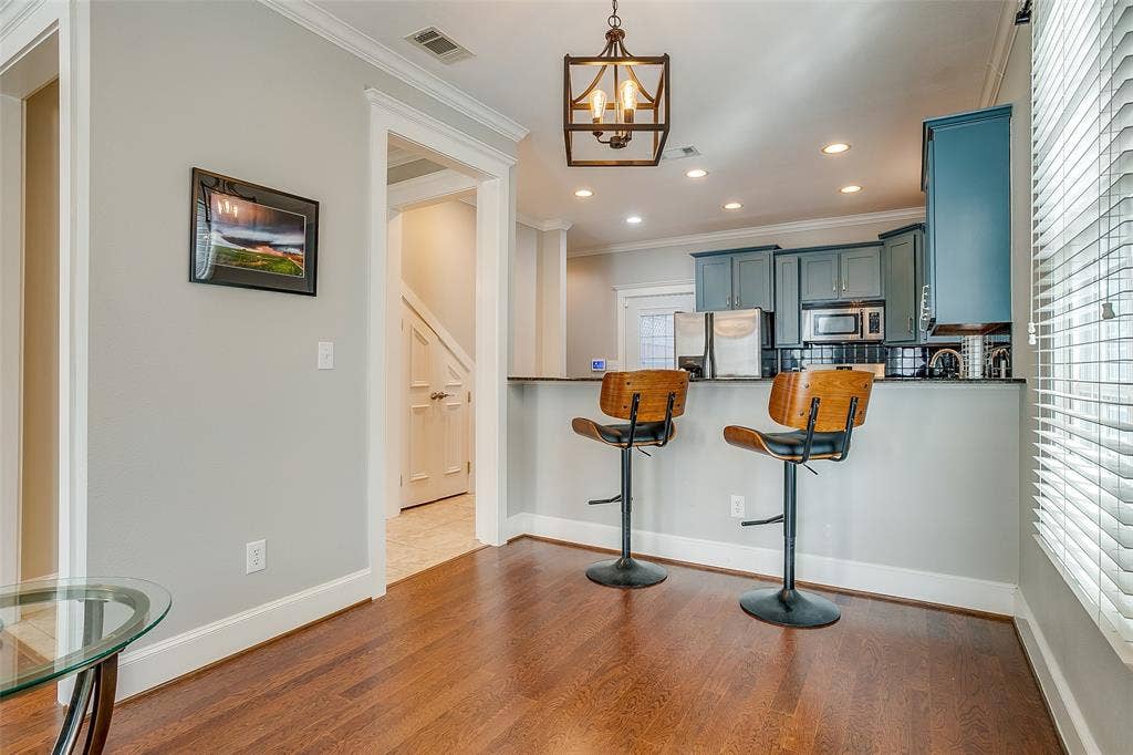 1211 S Adams Street, Fort Worth, TX 76104 Kitchen bar area featuring wood-finish flooring, a pendant light fixture, and recessed lighting