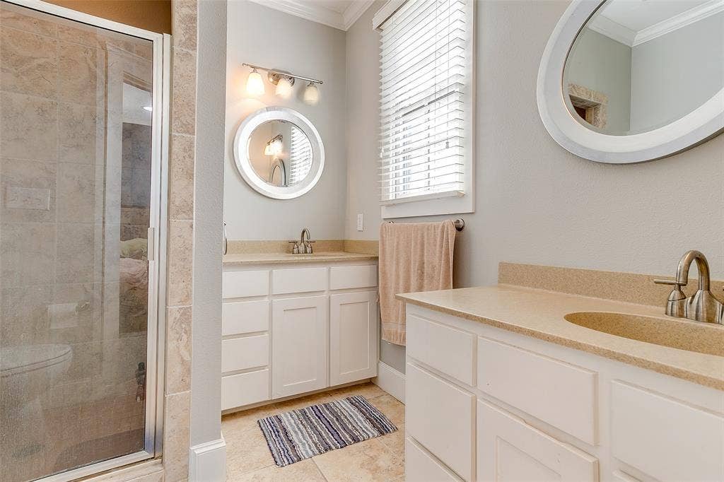 1211 S Adams Street, Fort Worth, TX 76104 Dual vanity with light-colored countertops and white cabinetry