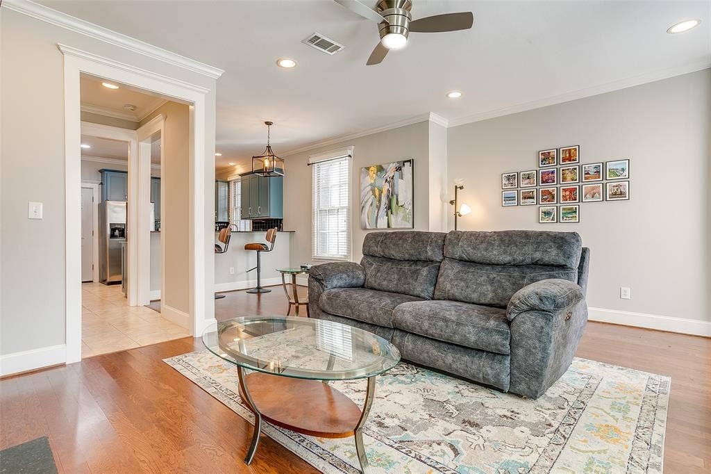 1211 S Adams Street, Fort Worth, TX 76104 Open-concept living area featuring rich wood-finish flooring, recessed lighting, and a ceiling fan