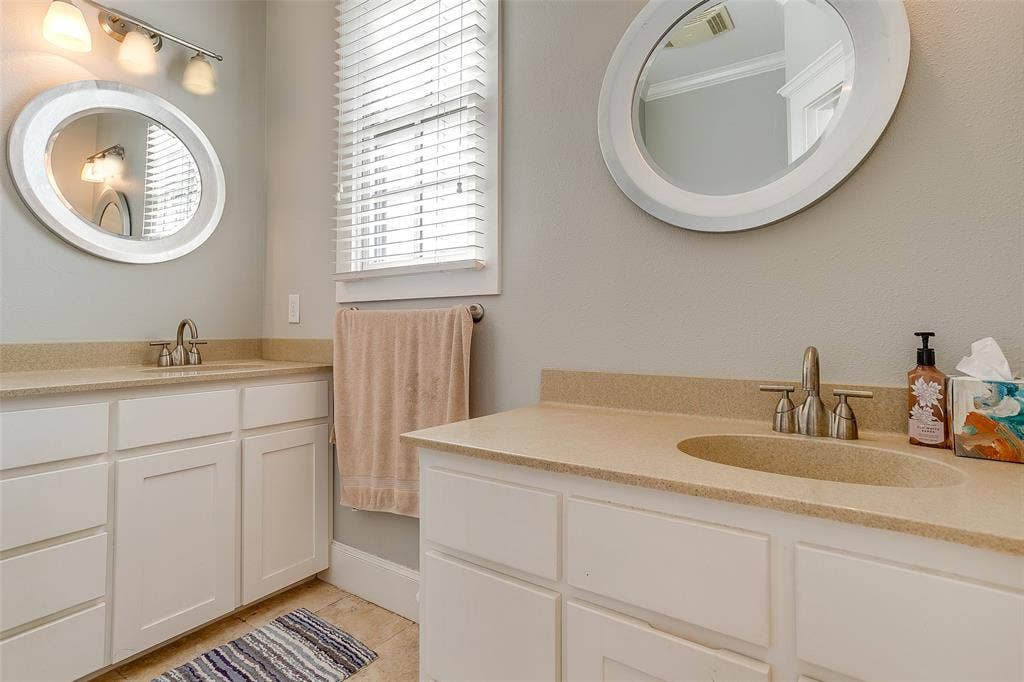 1211 S Adams Street, Fort Worth, TX 76104 Dual vanity bathroom with light-toned countertops and integrated sinks