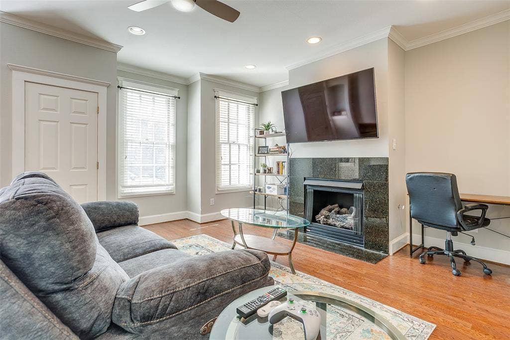1211 S Adams Street, Fort Worth, TX 76104 Living area featuring wood-finish flooring and a ceiling fan