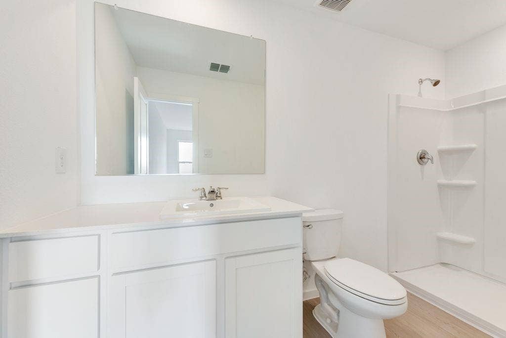 1271 Falcon Heights, Forney, TX 75126 Bathroom featuring vanity, a shower, and wood finished floors