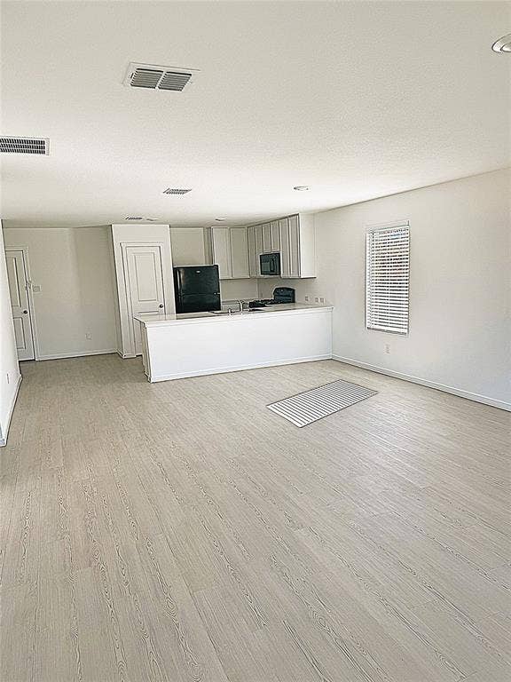 1271 Falcon Heights, Forney, TX 75126 Unfurnished living room with light wood-style flooring and baseboards