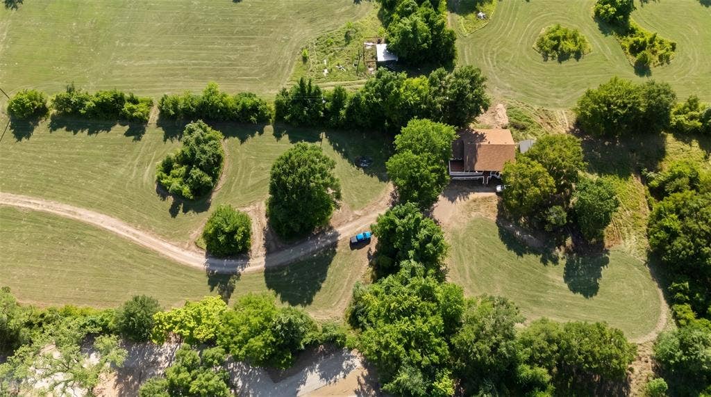 28300 County Road 2100, Kemp, TX 75143 Expansive property featuring a detached residence with a visible brown roof, surrounded by mature trees and verdant lawns