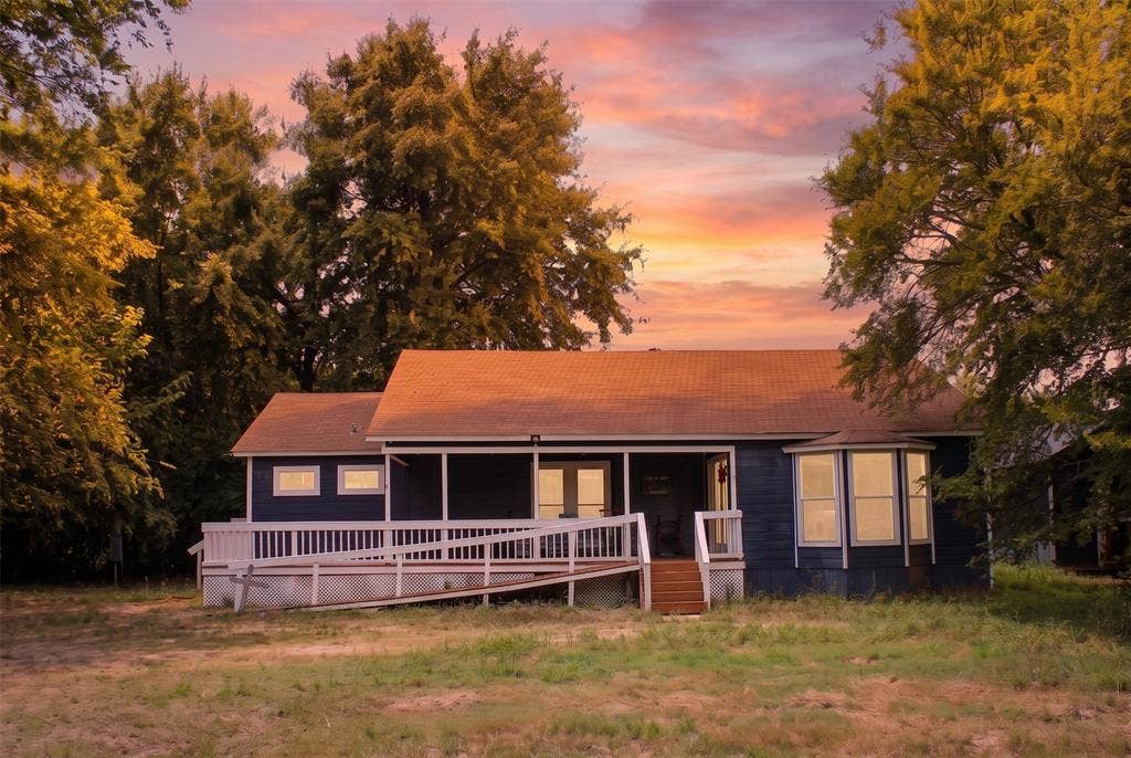 28300 County Road 2100, Kemp, TX 75143 Single-story residence featuring a dark blue exterior siding and a brown shingle roof