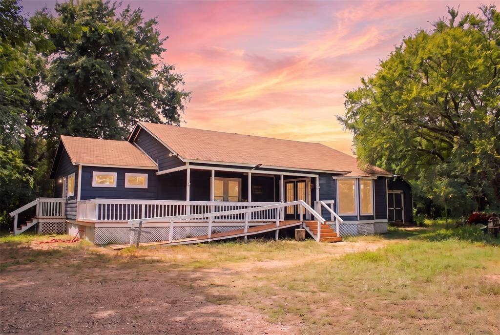 28300 County Road 2100, Kemp, TX 75143 Single-story home featuring a dark exterior, a light-colored shingle roof, and a full-width front porch
