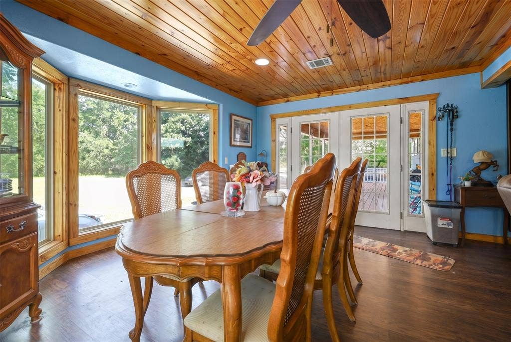 28300 County Road 2100, Kemp, TX 75143 Dining space featuring a natural wood plank ceiling, a bay window with wood trim, and wood-finish flooring