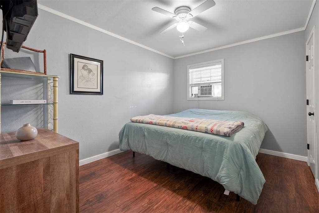28300 County Road 2100, Kemp, TX 75143 Interior room featuring wood-finish flooring, light gray walls, and white crown molding