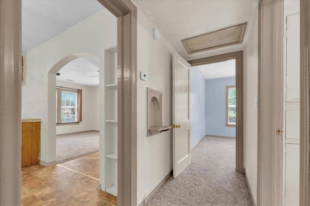 1113 Hudgins Avenue, Fort Worth, TX 76111 Interior hallway featuring carpeted flooring and an attic access panel