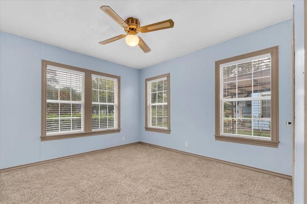 1113 Hudgins Avenue, Fort Worth, TX 76111 Room featuring light blue walls and neutral carpet flooring
