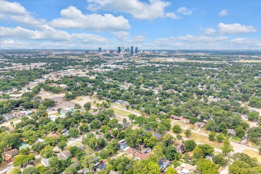 1113 Hudgins Avenue, Fort Worth, TX 76111 Aerial perspective showcasing a sprawling urban landscape with a distant city skyline