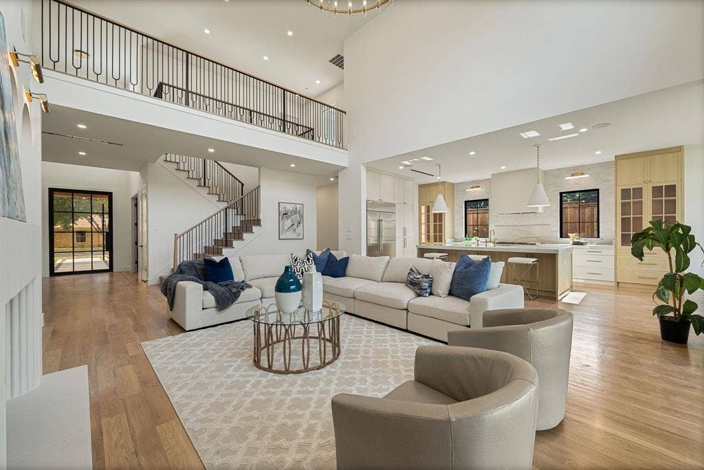3723 Manana Drive, Dallas, TX 75220 Open-concept living space featuring high ceilings, wood-finish flooring, and a contemporary kitchen with an island