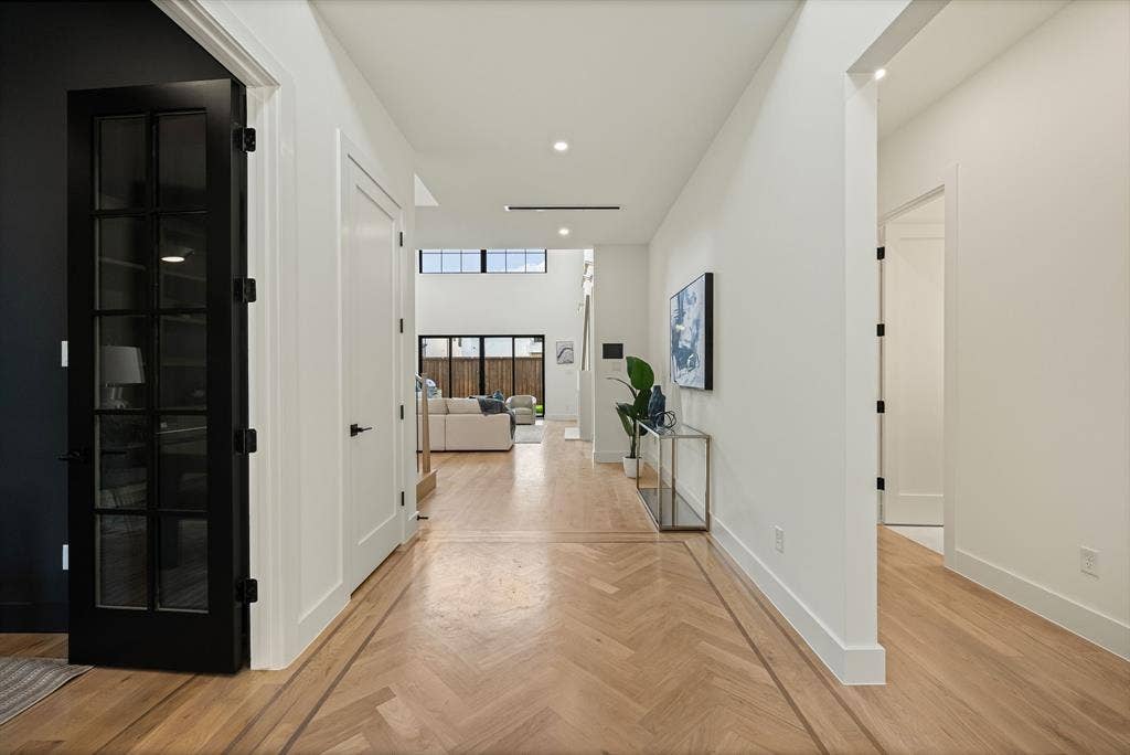 3723 Manana Drive, Dallas, TX 75220 Herringbone wood-finish flooring with a perimeter inlay, white walls, and recessed lighting