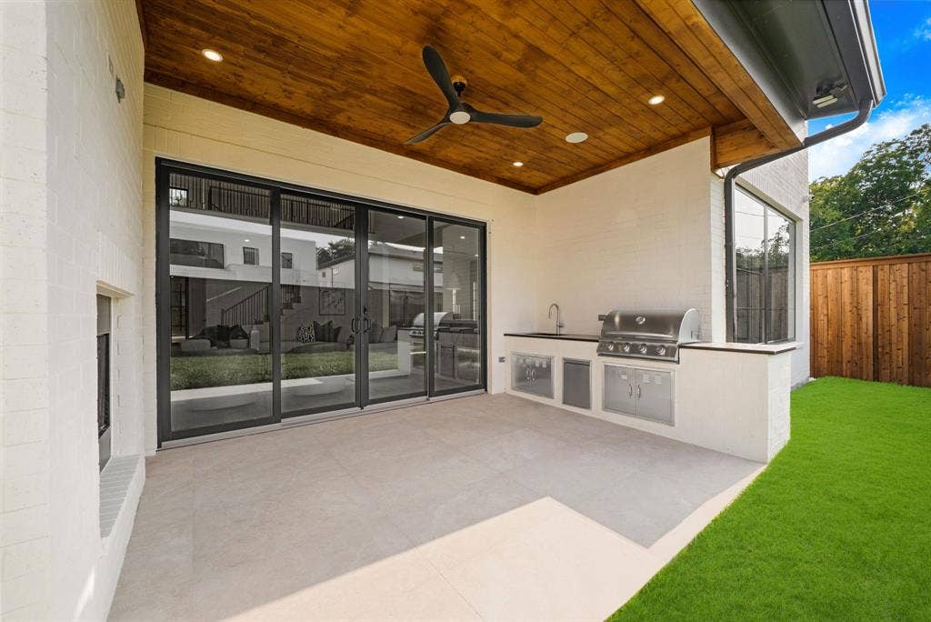 3723 Manana Drive, Dallas, TX 75220 Covered outdoor living space featuring an integrated outdoor kitchen with a built-in grill, sink, and under-counter refrigeration