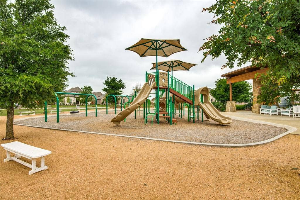 12464 Lost Valley Drive, Frisco, TX 75035 Community playground featuring shade umbrellas, multiple slides, and swing sets
