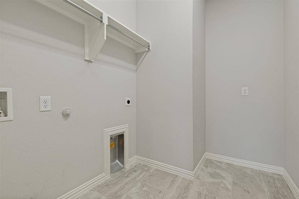 12464 Lost Valley Drive, Frisco, TX 75035 Utility space featuring light gray walls, layered baseboards, and gray marble-look floor tiles