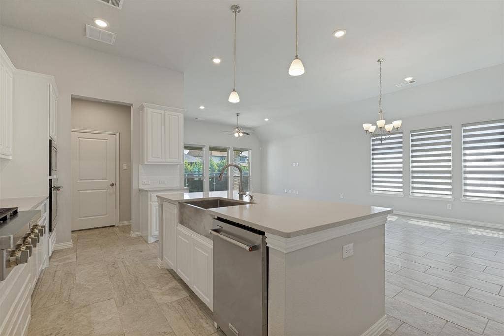 12464 Lost Valley Drive, Frisco, TX 75035 Open-concept kitchen featuring an oversized island with a farmhouse sink and stainless steel dishwasher