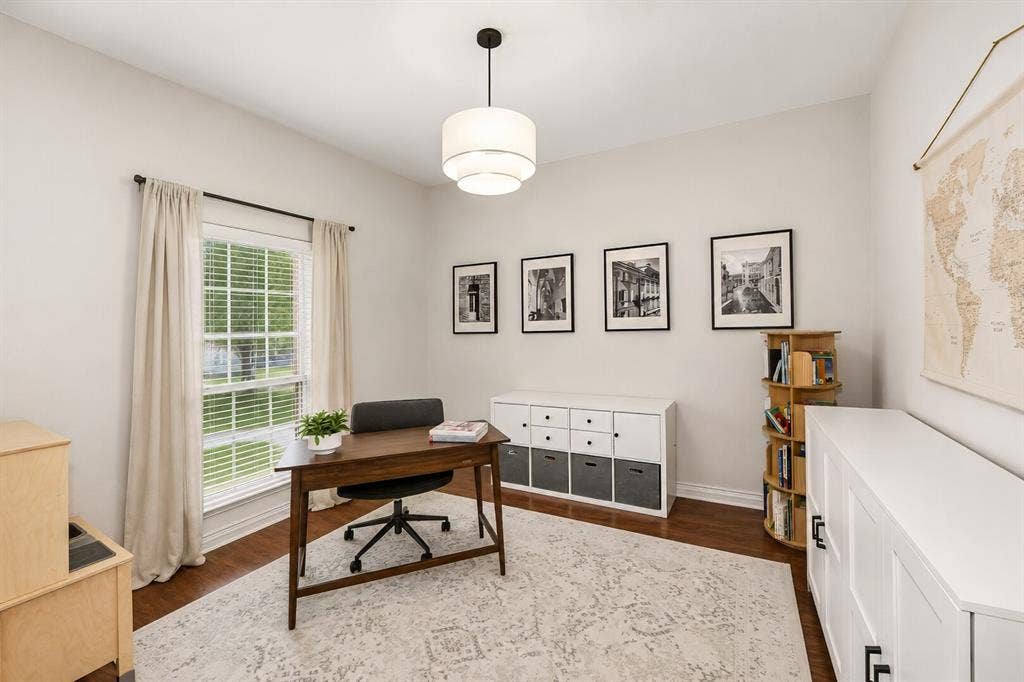 5304 Fox Run Drive, Watauga, TX 76137 A bright and versatile home office features a large window, rich engineered hardwood flooring, and modern finishes, creating the perfect space for working from home, studying, or a quiet reading retreat.