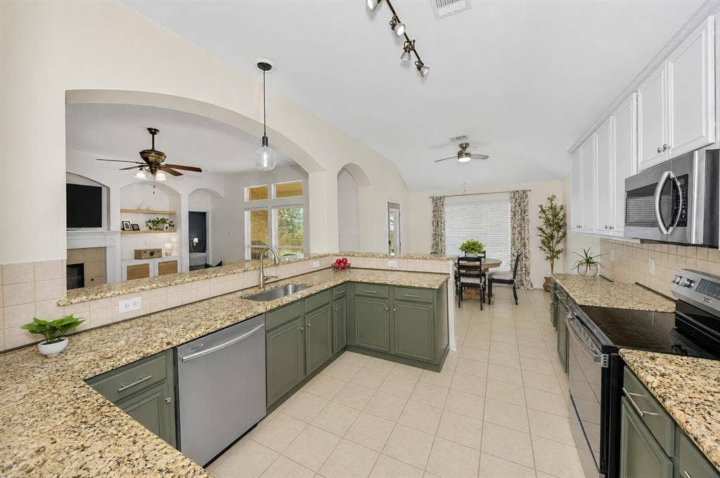 5304 Fox Run Drive, Watauga, TX 76137 This amazing kitchen features custom designer lighting over the sink and on a track overhead. Cereal at the large breakfast bar is great for the kids.