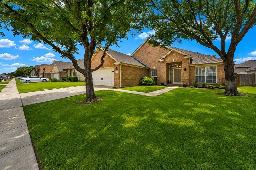 5304 Fox Run Drive, Watauga, TX 76137 Towering mature trees create a picturesque setting, adding natural elegance, cooling shade, and year-round beauty to this beautifully landscaped property.