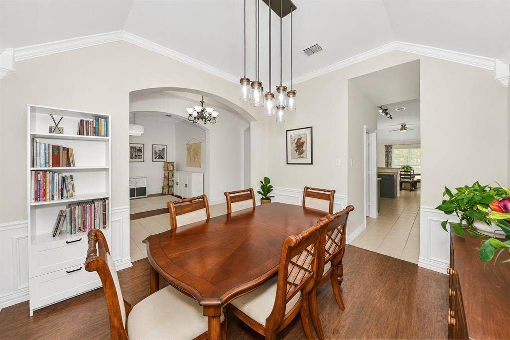 5304 Fox Run Drive, Watauga, TX 76137 The elegant formal dining room features rich engineered hardwood floors, soaring ceilings, stylish pendant lighting, and an open design with perfect access to the kitchen for hosting memorable dinners and holiday gatherings.