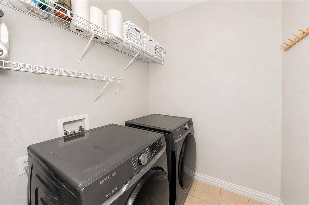 5304 Fox Run Drive, Watauga, TX 76137 The spacious laundry room offers a modern washer and dryer that stay with an acceptable offer. Ample shelving offer storage and organization, and plenty of room to make everyday chores efficient and convenient.