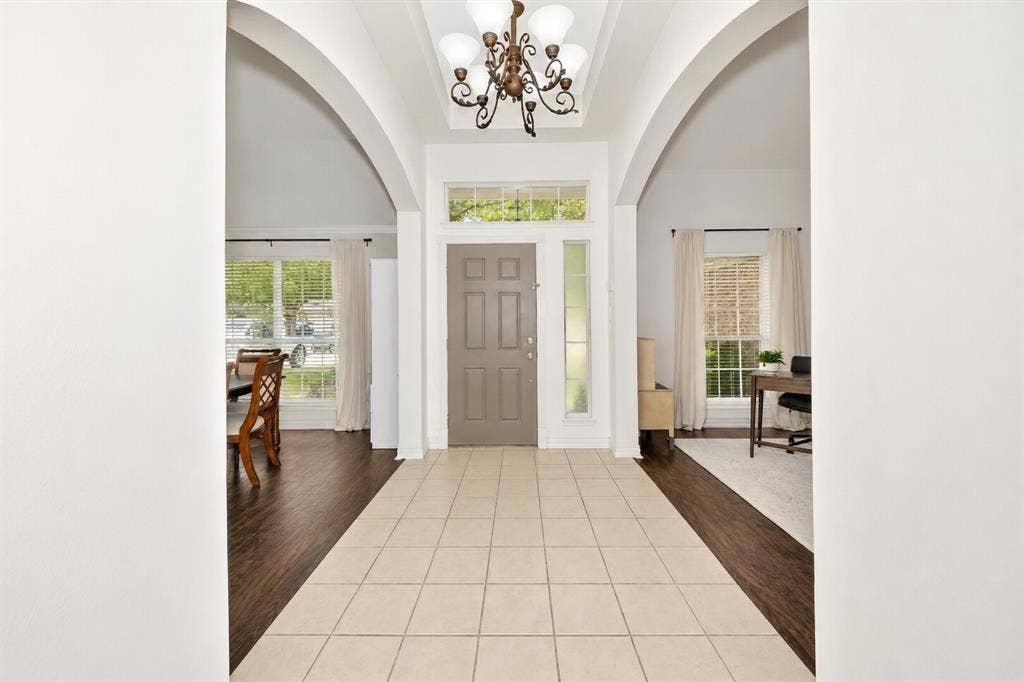 5304 Fox Run Drive, Watauga, TX 76137 A grand foyer welcomes you with soaring ceilings, elegant arched entryways, abundant natural light, and a versatile layout that seamlessly connects the formal dining room and private home office.