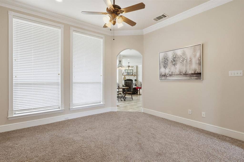 5030 Monroe Court, Midlothian, TX 76065 Neutral tone wall paint with white trim, a decorative arched doorway, and recessed lighting