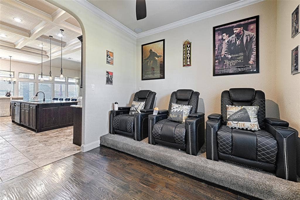 Dedicated media space featuring tiered seating on carpeted risers and crown molding