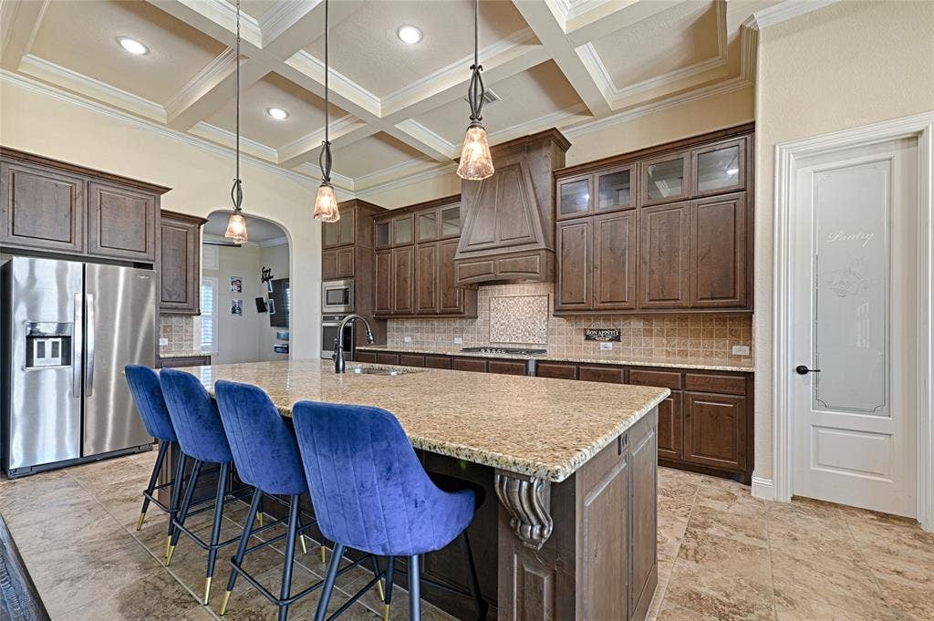 Main kitchen with huge island and custom ceiling