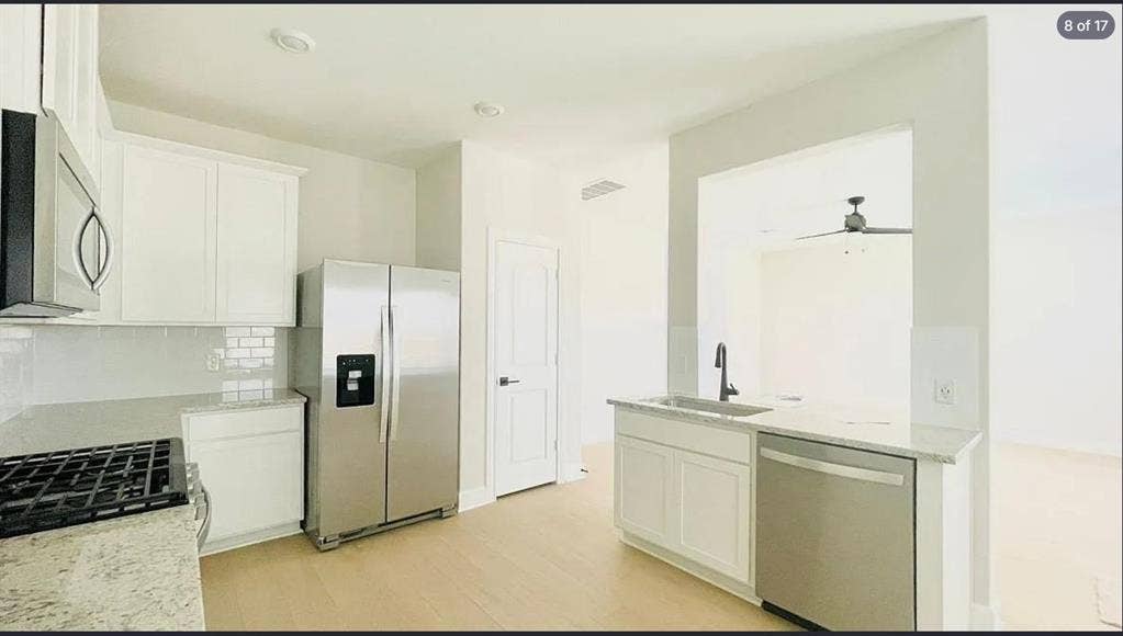 1323 windermere Way, Princeton, TX 75407 Modern kitchen featuring light wood-finish flooring, white cabinetry, and light-toned countertops