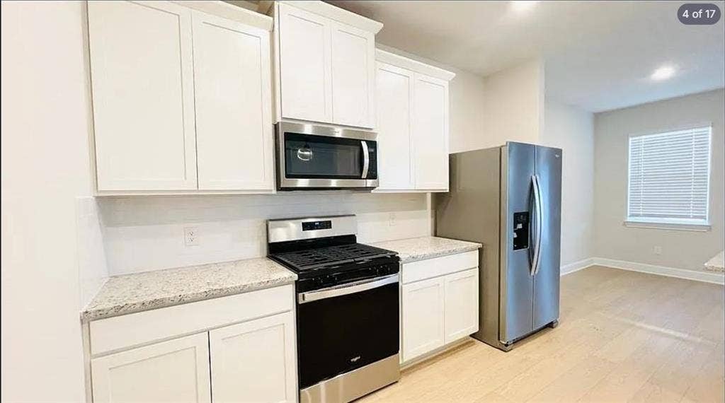 1323 windermere Way, Princeton, TX 75407 Kitchen featuring white shaker-style cabinetry, granite countertops, stainless steel appliances, and subway tile backsplash