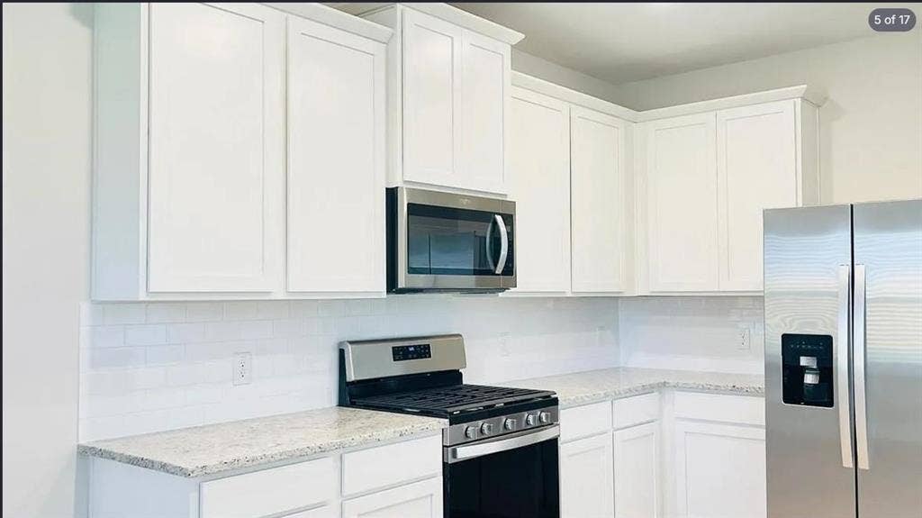 1323 windermere Way, Princeton, TX 75407 Kitchen featuring white shaker-style cabinetry, light-colored speckled countertops, a white subway tile backsplash, stainless steel appliances, and a built-in microwave