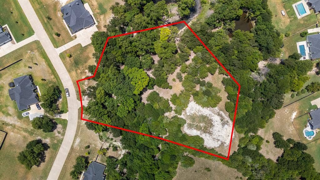 Generous wooded lot featuring a partial clearing and established street frontage