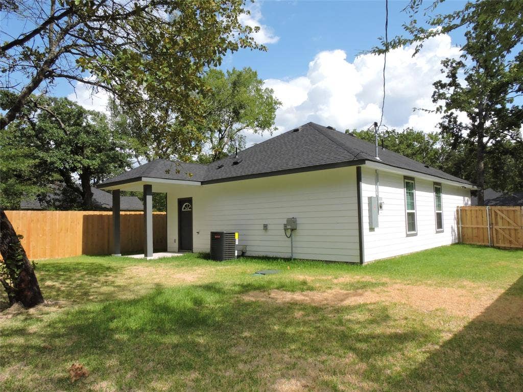 6110 Tejas Drive, Mabank, TX 75156 White siding exterior with a dark shingle roof and a covered patio area