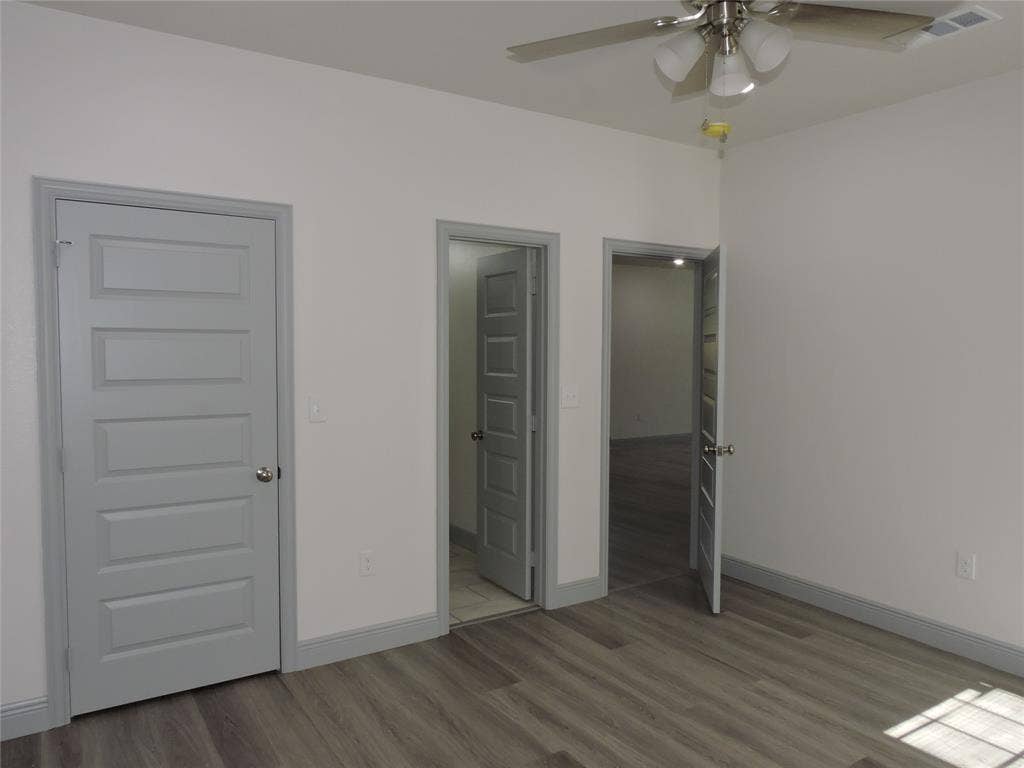 6110 Tejas Drive, Mabank, TX 75156 Interior room featuring wood-finish flooring, white painted walls, and gray trim